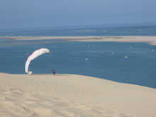 a-paraglider-uses-the-dune-de-pilat-as-a-launch-pad